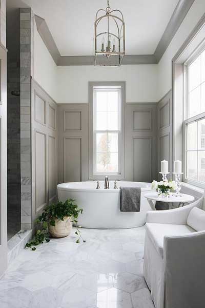 A Gorgeously Elegant Bathroom Done With Light Grey Paneling Marble Hex Tiles On The Floor White Furniture And A Contemporary Oval Tub 1920w A Gorgeously Elegant Bathroom Done With Light Grey Paneling Marble Hex Tiles On The Floor White Furniture And A Contemporary Oval Tub 1920w